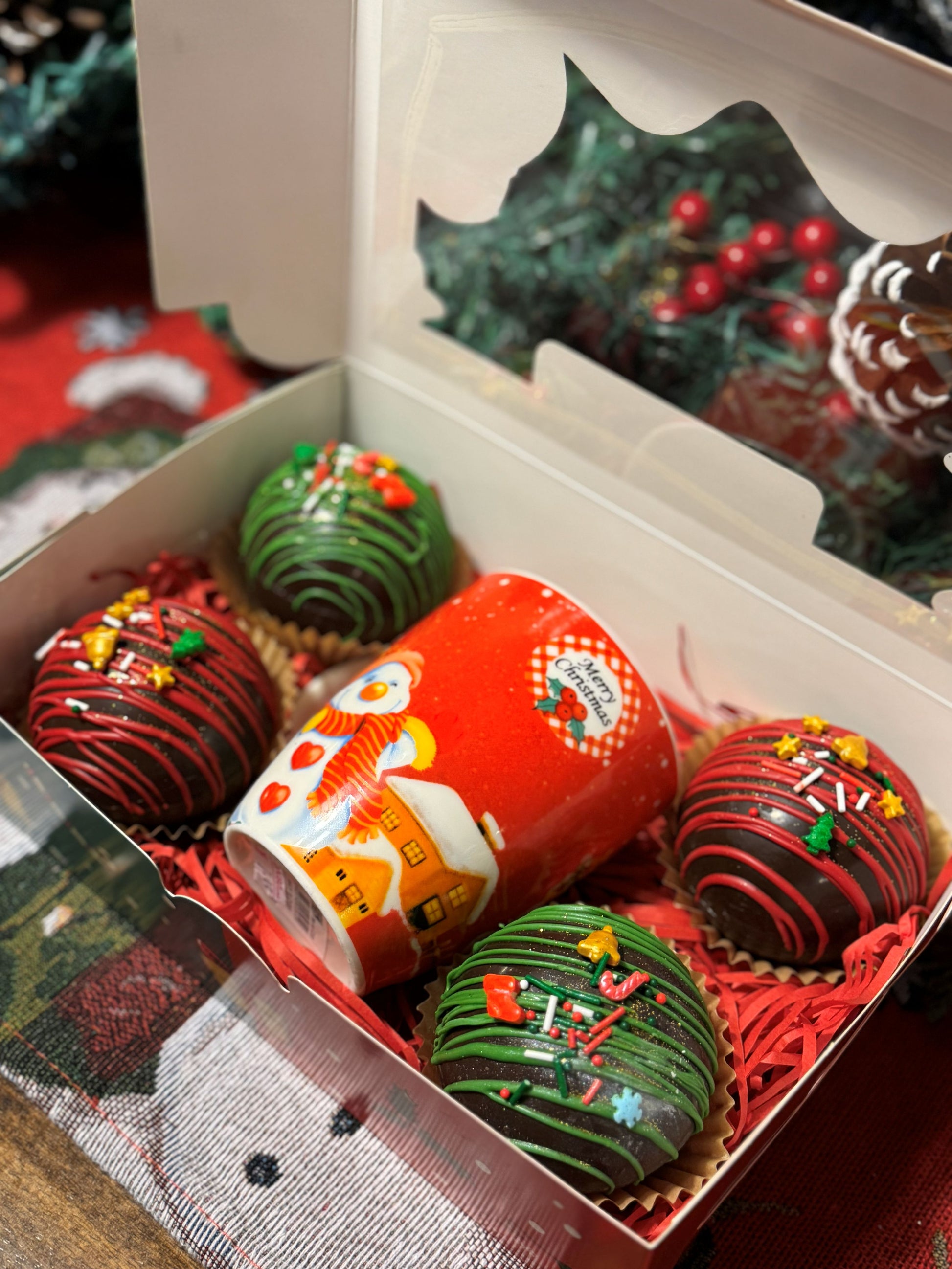 Christmas Cocoa Bombs in a festive box with a colorful Christmas mug, perfect for chocolate special occasions.