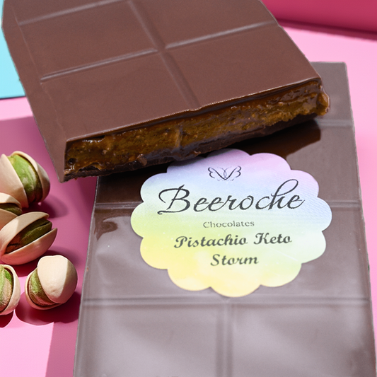 Keto Chocolate bar with pistachio praline wrapped in dark chocolate, featuring a colorful label on a vibrant background.